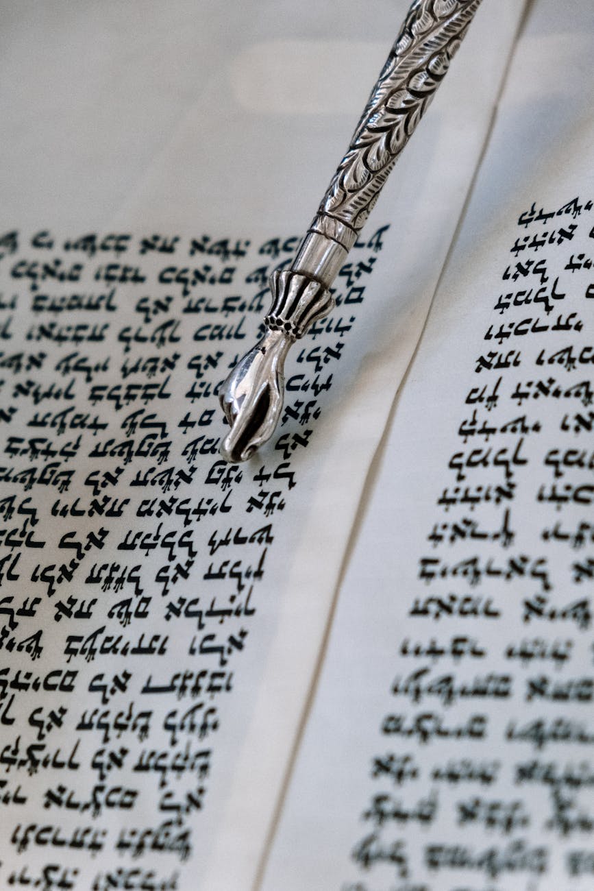 silver pointer on the white paper with writings